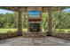 Outdoor fireplace with stone surround and mantle in screened patio at 6050 Saddle Oak Trl, Sarasota, FL 34241