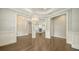 Open concept foyer with beautiful hardwood floors and decorative chandelier at 6050 Saddle Oak Trl, Sarasota, FL 34241