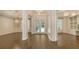 Spacious foyer with hardwood floors and white trim leads to the dining room, office, and main living area at 6050 Saddle Oak Trl, Sarasota, FL 34241