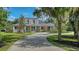 Gorgeous front exterior view of the home featuring a long driveway and mature trees at 6050 Saddle Oak Trl, Sarasota, FL 34241