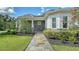 Stunning stone walkway, manicured landscaping, and stone accents frame the home's elegant exterior at 6050 Saddle Oak Trl, Sarasota, FL 34241
