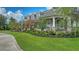 Charming one-story home with a well-manicured lawn, lush landscaping and a welcoming front porch at 6050 Saddle Oak Trl, Sarasota, FL 34241