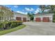 Spacious garages with stone accents and meticulously maintained landscaping offer plenty of parking at 6050 Saddle Oak Trl, Sarasota, FL 34241