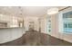 Bright, white kitchen featuring a large island with marble countertops, custom cabinetry, and stainless steel appliances at 6050 Saddle Oak Trl, Sarasota, FL 34241