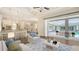 Living room features an open floor plan, modern décor, and access to lanai and pool at 6050 Saddle Oak Trl, Sarasota, FL 34241