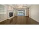 Elegant living room with wood floors, fireplace, custom built-ins, and a view of the lanai and pool at 6050 Saddle Oak Trl, Sarasota, FL 34241
