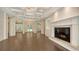 Bright living room with elegant coffered ceilings, fireplace, and views of the front yard through double glass doors at 6050 Saddle Oak Trl, Sarasota, FL 34241