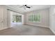 Living room with access to the outside patio, neutral walls, and a patterned carpet at 6050 Saddle Oak Trl, Sarasota, FL 34241