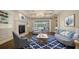 Inviting living room with fireplace, custom built-ins, and bright, light-filled view of the pool at 6050 Saddle Oak Trl, Sarasota, FL 34241