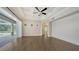 Open living area with access to an outdoor patio and sleek ceiling fan at 6050 Saddle Oak Trl, Sarasota, FL 34241
