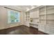 Bright office featuring custom built-ins, a desk area, and large windows for natural light at 6050 Saddle Oak Trl, Sarasota, FL 34241