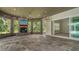 Wide outdoor patio with stone fireplace, mounted TV, and views of the garden at 6050 Saddle Oak Trl, Sarasota, FL 34241