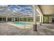 Outdoor pool and patio area featuring a screened enclosure and stone columns at 6050 Saddle Oak Trl, Sarasota, FL 34241