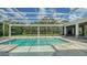 Inviting screened-in pool area, offering a relaxing outdoor oasis with views of the lush greenery at 6050 Saddle Oak Trl, Sarasota, FL 34241