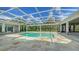 Relaxing screened-in pool with stunning stone patio and ample seating areas for outdoor entertaining at 6050 Saddle Oak Trl, Sarasota, FL 34241