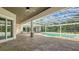 Covered patio overlooking a beautiful pool area and lush landscaping, perfect for outdoor entertaining at 6050 Saddle Oak Trl, Sarasota, FL 34241