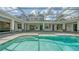 Inviting pool featuring steps, stone decking and screened enclosure merging indoor/outdoor living at 6050 Saddle Oak Trl, Sarasota, FL 34241