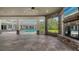 Outdoor pool and patio featuring stone columns and views of the garden at 6050 Saddle Oak Trl, Sarasota, FL 34241