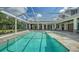 Stunning screened-in pool with stone deck, covered lanai, and serene backyard views at 6050 Saddle Oak Trl, Sarasota, FL 34241