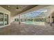 Outdoor pool area surrounded by screened enclosure and natural stone pavers at 6050 Saddle Oak Trl, Sarasota, FL 34241