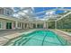 Outdoor pool with a screened enclosure, stone pavers, and outdoor house access at 6050 Saddle Oak Trl, Sarasota, FL 34241