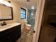 Bathroom with modern fixtures, sleek vanity, and tiled shower stall at 611 Missouri Rd, Venice, FL 34293
