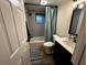 Bathroom with modern fixtures, sleek vanity, bathtub, and tiled shower at 611 Missouri Rd, Venice, FL 34293