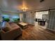 Inviting living room with wood floors, sliding doors and views into the kitchen at 611 Missouri Rd, Venice, FL 34293