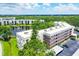 An elevated view showcasing the property's buildings, manicured grounds, lake, and proximity to green spaces at 6188 80Th N St # 102, St Petersburg, FL 33709