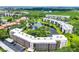 Aerial view showcasing the community's layout, with buildings encircling a central lake amidst lush greenery at 6188 80Th N St # 102, St Petersburg, FL 33709