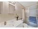 Bathroom with white vanity, decorative flower, and shower with sliding glass door at 6188 80Th N St # 102, St Petersburg, FL 33709