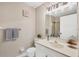Bathroom with a bright vanity, decorative plant, and a framed mirror with vanity lights at 6188 80Th N St # 102, St Petersburg, FL 33709