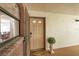 A welcoming front door with a welcome mat and decorative planter; glimpse of the interior dining area at 6188 80Th N St # 102, St Petersburg, FL 33709
