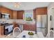 Galley kitchen boasting stainless steel appliances, tile floors, breakfast nook, and granite counters at 6188 80Th N St # 102, St Petersburg, FL 33709