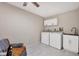 Well-equipped laundry room with modern appliances, white cabinets and a utility sink at 6188 80Th N St # 102, St Petersburg, FL 33709