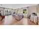 Bright living room with hardwood floors, comfortable seating, and a view of the lake through the sliding glass doors at 6188 80Th N St # 102, St Petersburg, FL 33709