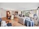 Spacious living area open to dining, featuring hardwood floors, bright lighting, and sliding door to a screened porch at 6188 80Th N St # 102, St Petersburg, FL 33709