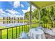 Relaxing patio with seating overlooking a scenic lake and lush green landscape at 6188 80Th N St # 102, St Petersburg, FL 33709