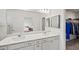 Bright bathroom with double sinks, a vanity, and a view into the bedroom and walk in closet at 6612 Silverstar Dr, Sarasota, FL 34240
