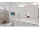 Elegant bathroom featuring a walk-in shower, and dual vanity sinks with a large mirror at 6612 Silverstar Dr, Sarasota, FL 34240