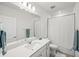 Bathroom with a large mirror, white cabinets and a shower with a curtain at 6612 Silverstar Dr, Sarasota, FL 34240