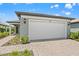 Attractive home exterior featuring a two-car garage, well-maintained landscaping, and a paved driveway at 6612 Silverstar Dr, Sarasota, FL 34240