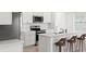 Bright kitchen featuring stainless steel appliances, including an oven and microwave, complemented by an island with barstool seating at 6612 Silverstar Dr, Sarasota, FL 34240