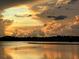 Picturesque sunset view overlooking the lake with dramatic clouds reflecting on the calm water at 6612 Silverstar Dr, Sarasota, FL 34240