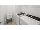 Functional laundry room equipped with a modern washer and dryer, sink, and wire shelving at 6612 Silverstar Dr, Sarasota, FL 34240