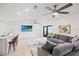 Open-concept living room with stylish furnishings, a TV, and bright natural light at 6612 Silverstar Dr, Sarasota, FL 34240