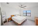 Comfortable main bedroom with a ceiling fan, lake views, and neutral decor at 6612 Silverstar Dr, Sarasota, FL 34240