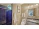 Stylish bathroom with a blue tiled shower and a granite countertop vanity at 6905 Pine Valley St, Bradenton, FL 34202