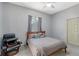 Cozy bedroom featuring a comfy chair, ceiling fan, and soothing natural light at 6905 Pine Valley St, Bradenton, FL 34202