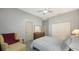 Relaxing bedroom featuring a comfortable chair, ceiling fan, and ample closet space at 6905 Pine Valley St, Bradenton, FL 34202